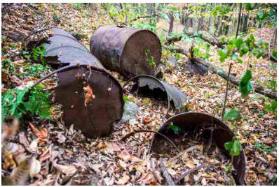 Metal drums and tannery waste at a former Wolverine World Wide dump site in Belmont, MI, https://www.mlive.com/news/grand-rapids/index.ssf/2017/11/varnum_wolverine_lawsuit.html